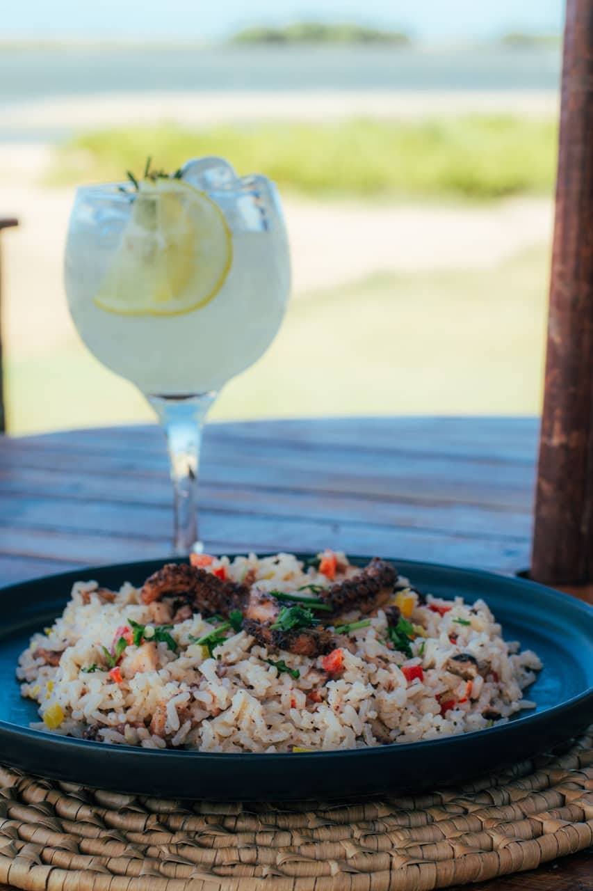 Risoto e drink servidos em frente à lagoa